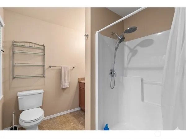 a bathroom with a toilet and a shower