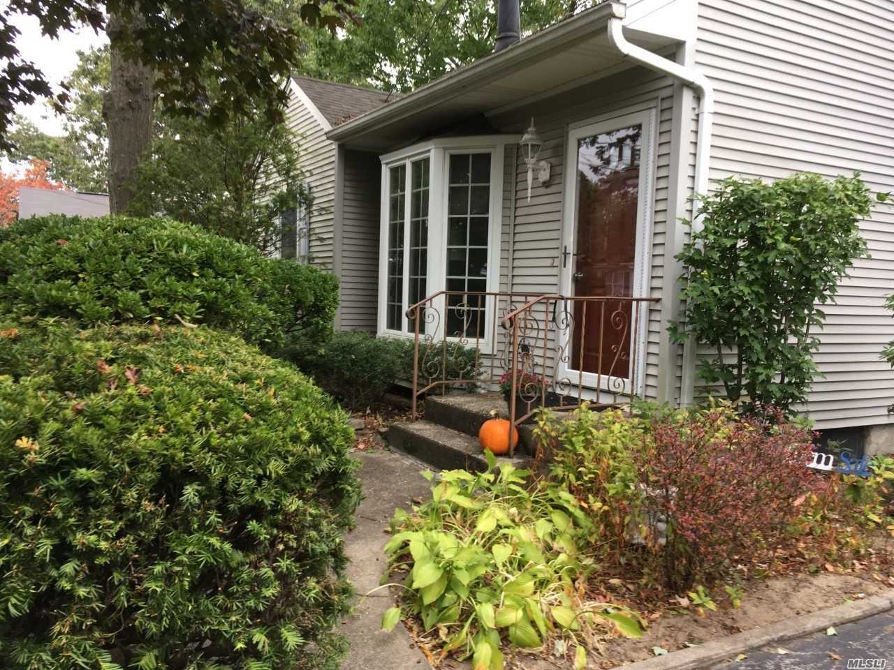 15 Carl Place Patchogue, NY 11772 - Photo 1 of 1 front view of a house with a yard
