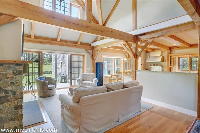 a living room with furniture and large windows