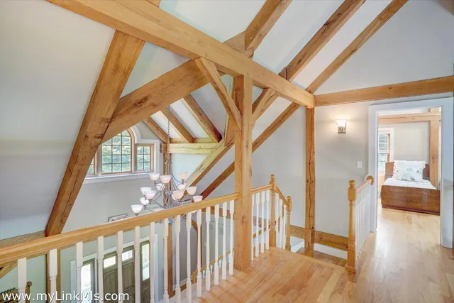 a view of an entryway with wooden floor and door