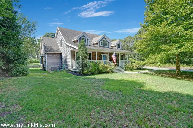 a front view of house with yard and green space