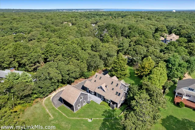 an aerial view of a house with a yard