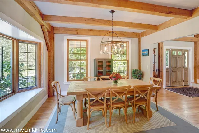a view of a dining room with furniture wooden floor and chandelier
