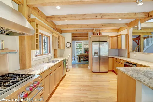 a kitchen with stainless steel appliances granite countertop a sink and cabinets