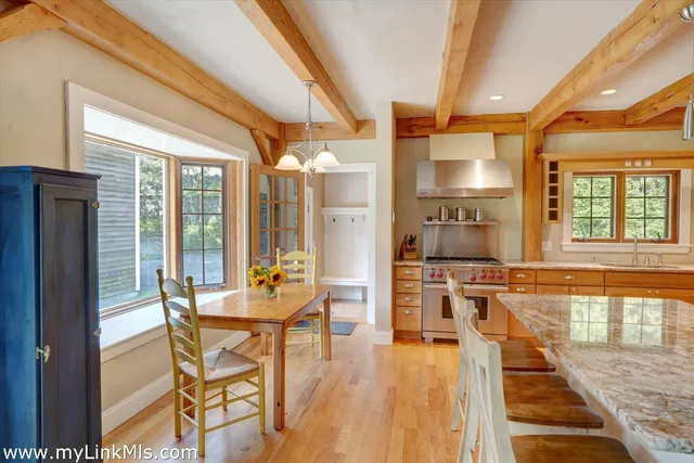a very nice looking dining room with a large window and chairs