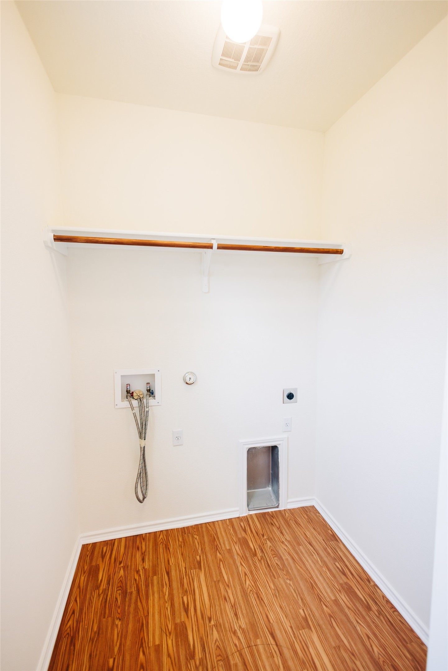 2905 Acopio Bend Austin, TX 78745 - Photo 11 of 29 Laundry room featuring dryer hookup, hookup for a washing machine, wood finished floors, and hookup for an electric dryer