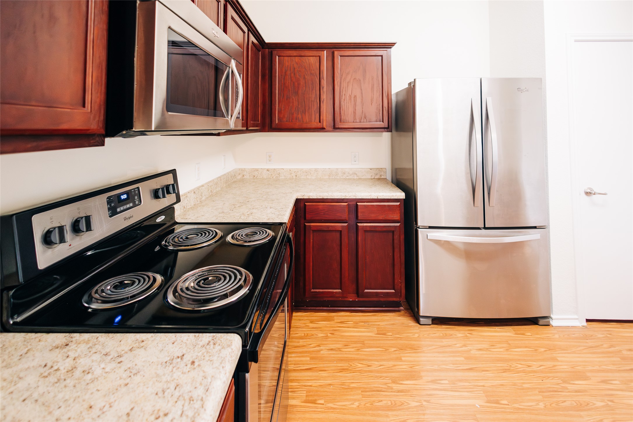 2905 Acopio Bend Austin, TX 78745 - Photo 9 of 29 Kitchen featuring stainless steel appliances, light countertops, and light wood-type flooring