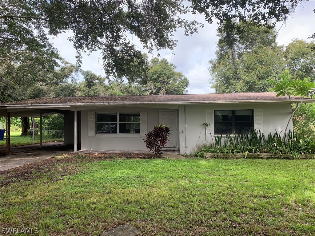 2819 W Road Fort Myers, FL 33905 - Photo 1 of 12 a front view of a house with garden and porch