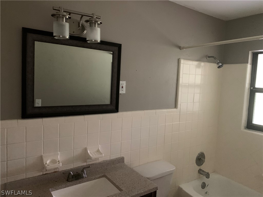 2819 W Road Fort Myers, FL 33905 - Photo 8 of 12 a bathroom with a sink a toilet and mirror