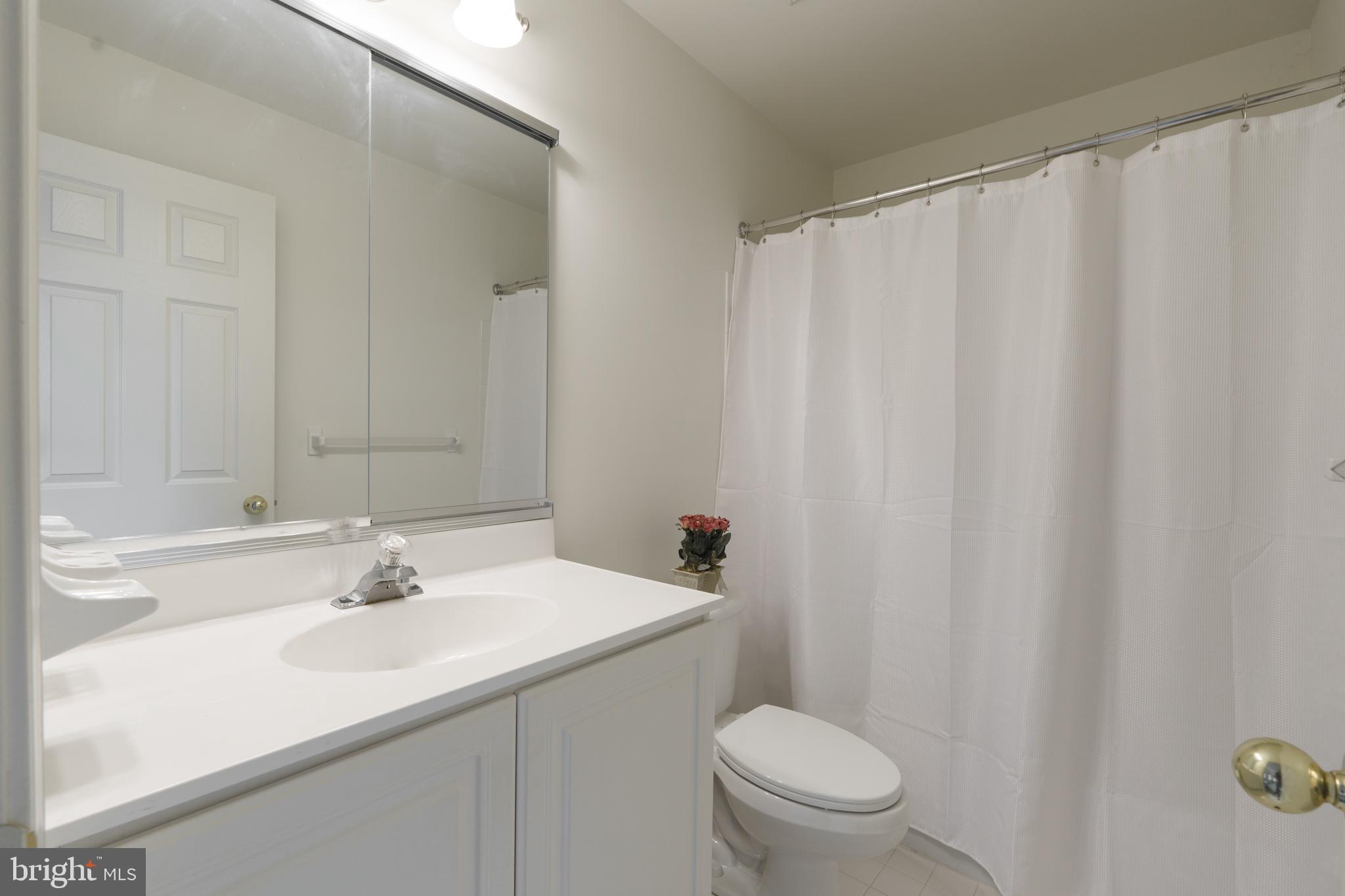 9 Corbin Drive Exton, PA 19341 - Photo 22 of 30 a bathroom with a sink a toilet and shower curtain