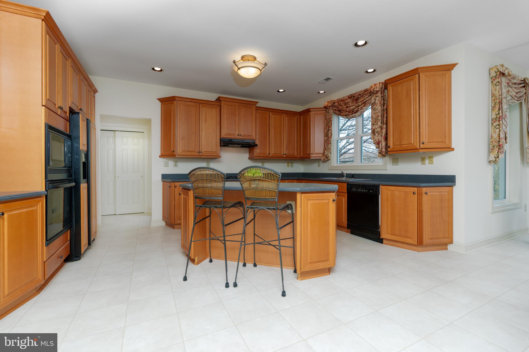 9 Corbin Drive Exton, PA 19341 - Photo 5 of 30 a kitchen with stainless steel appliances granite countertop a stove top oven a sink and a refrigerator