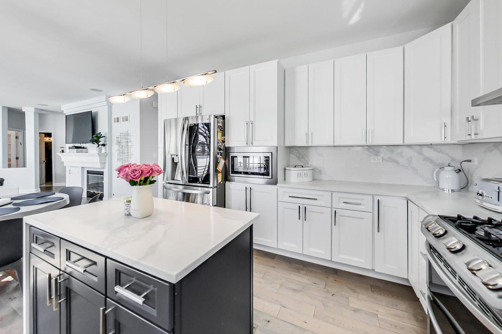 7311 Dada Drive Gurnee, IL 60031 - Photo 12 of 51 a kitchen with a sink a stove a refrigerator and white cabinets