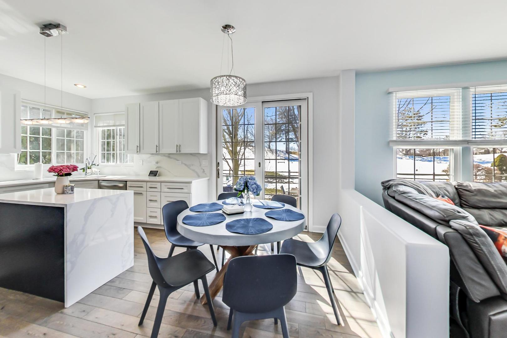 7311 Dada Drive Gurnee, IL 60031 - Photo 13 of 51 a kitchen with a dining table and chairs