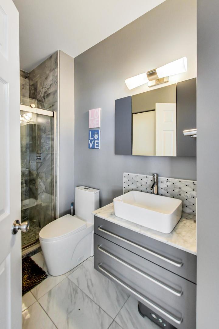 7311 Dada Drive Gurnee, IL 60031 - Photo 18 of 51 a bathroom with a sink and a mirror