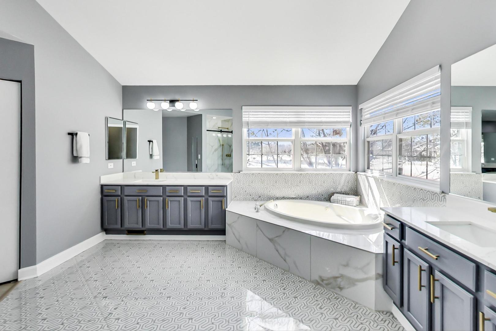 7311 Dada Drive Gurnee, IL 60031 - Photo 27 of 51 a spacious bathroom with a granite countertop double vanity sink a mirror and a bathtub