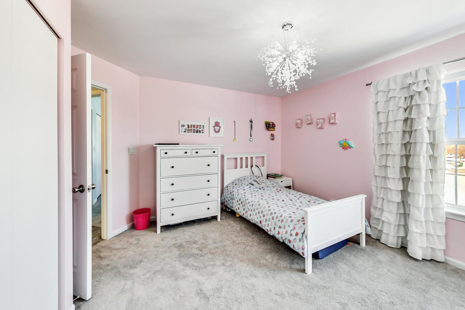 7311 Dada Drive Gurnee, IL 60031 - Photo 33 of 51 a bedroom with a bed and a chandelier