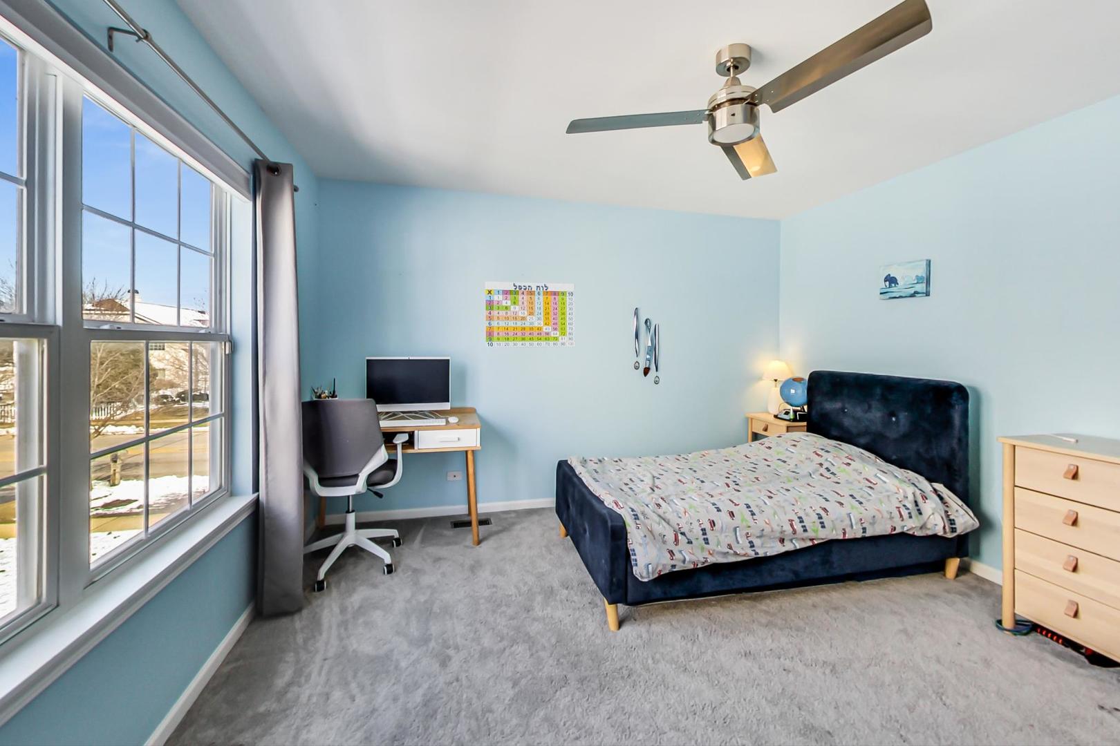 7311 Dada Drive Gurnee, IL 60031 - Photo 35 of 51 a bedroom with a bed and a chair