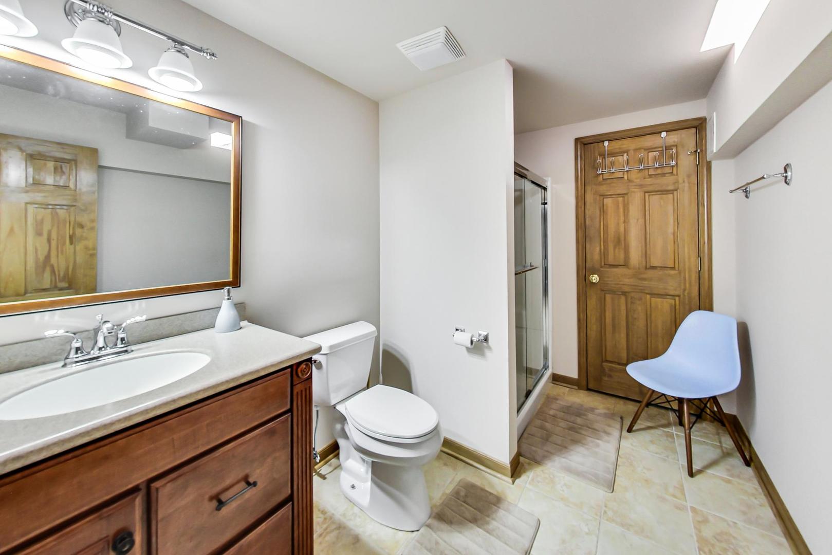 7311 Dada Drive Gurnee, IL 60031 - Photo 46 of 51 a bathroom with a granite countertop sink toilet a mirror and shower