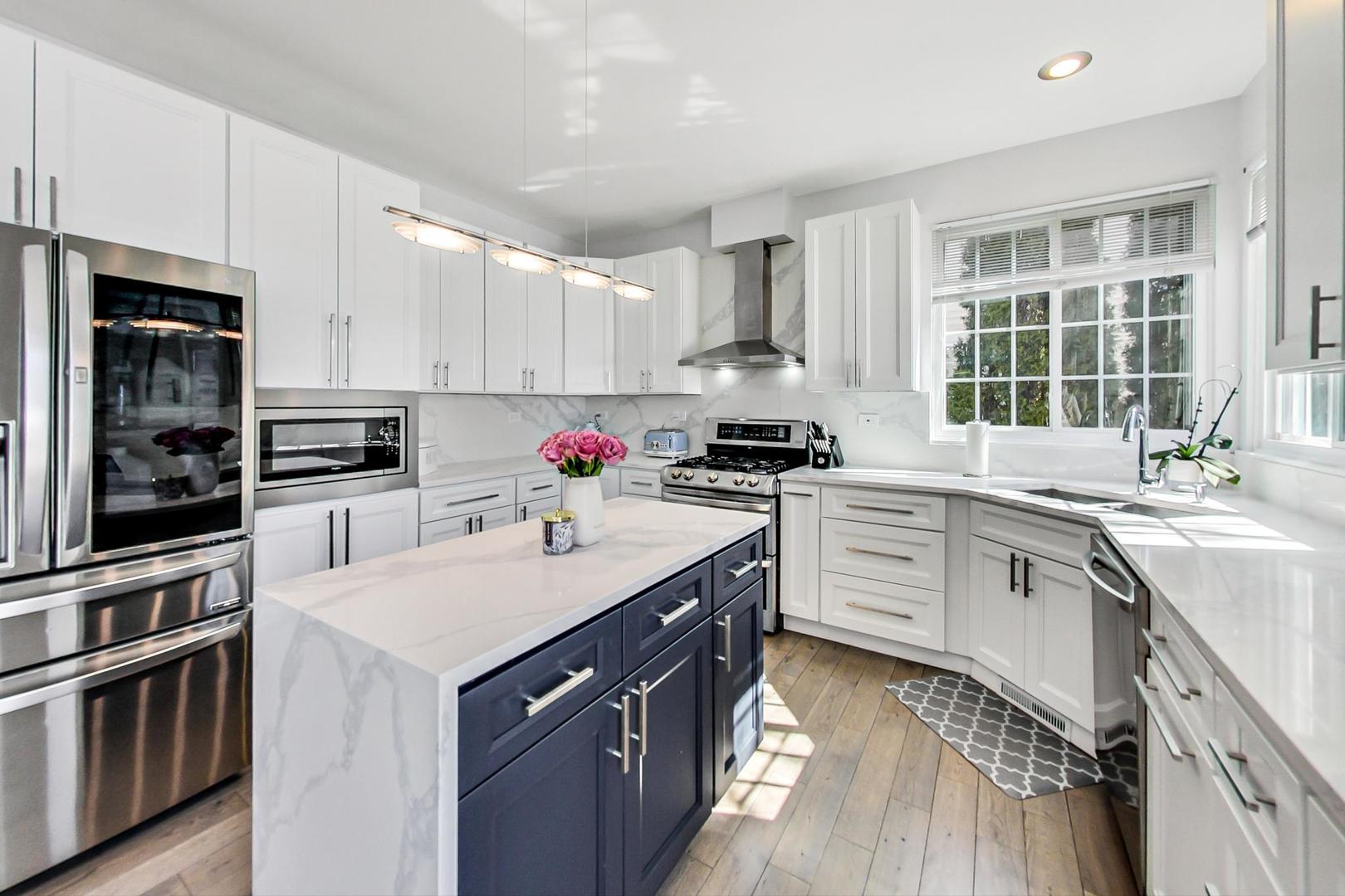 7311 Dada Drive Gurnee, IL 60031 - Photo 9 of 51 a kitchen with a sink stove and cabinets