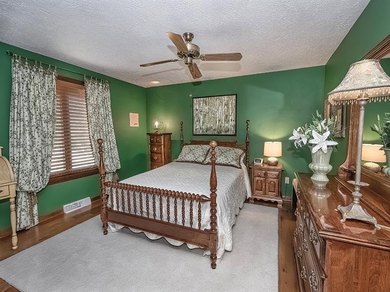 132 Ridge Drive Apollo, PA 15613 - Photo 11 of 37 a bed room with a bed and a chandelier