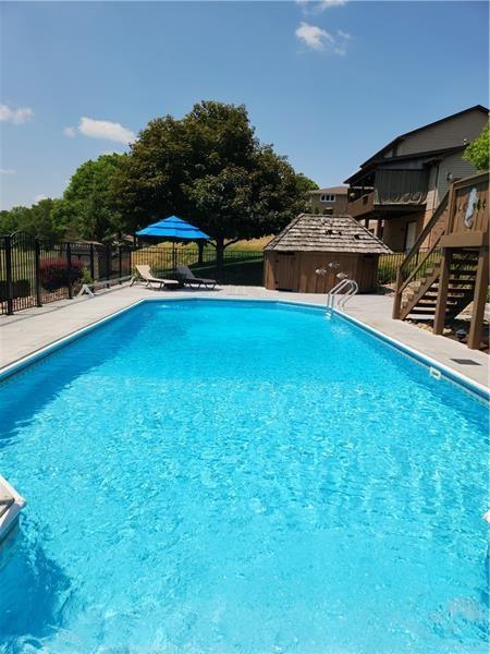 132 Ridge Drive Apollo, PA 15613 - Photo 36 of 37 a small pool with lawn chairs and a table