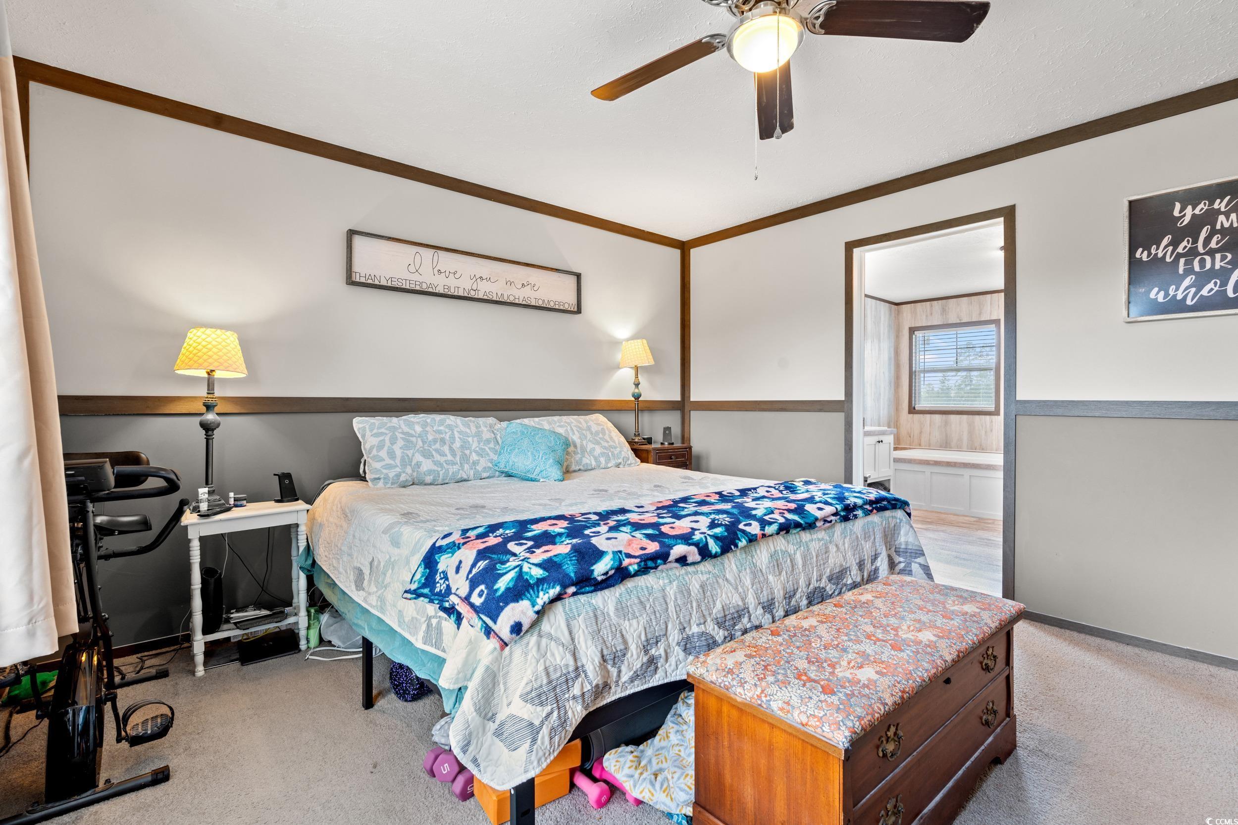 1217 Poplar Creek Road Lake View, SC 29563 - Photo 12 of 38 Bedroom featuring light carpet, a ceiling fan, wainscoting, crown molding, and ensuite bath