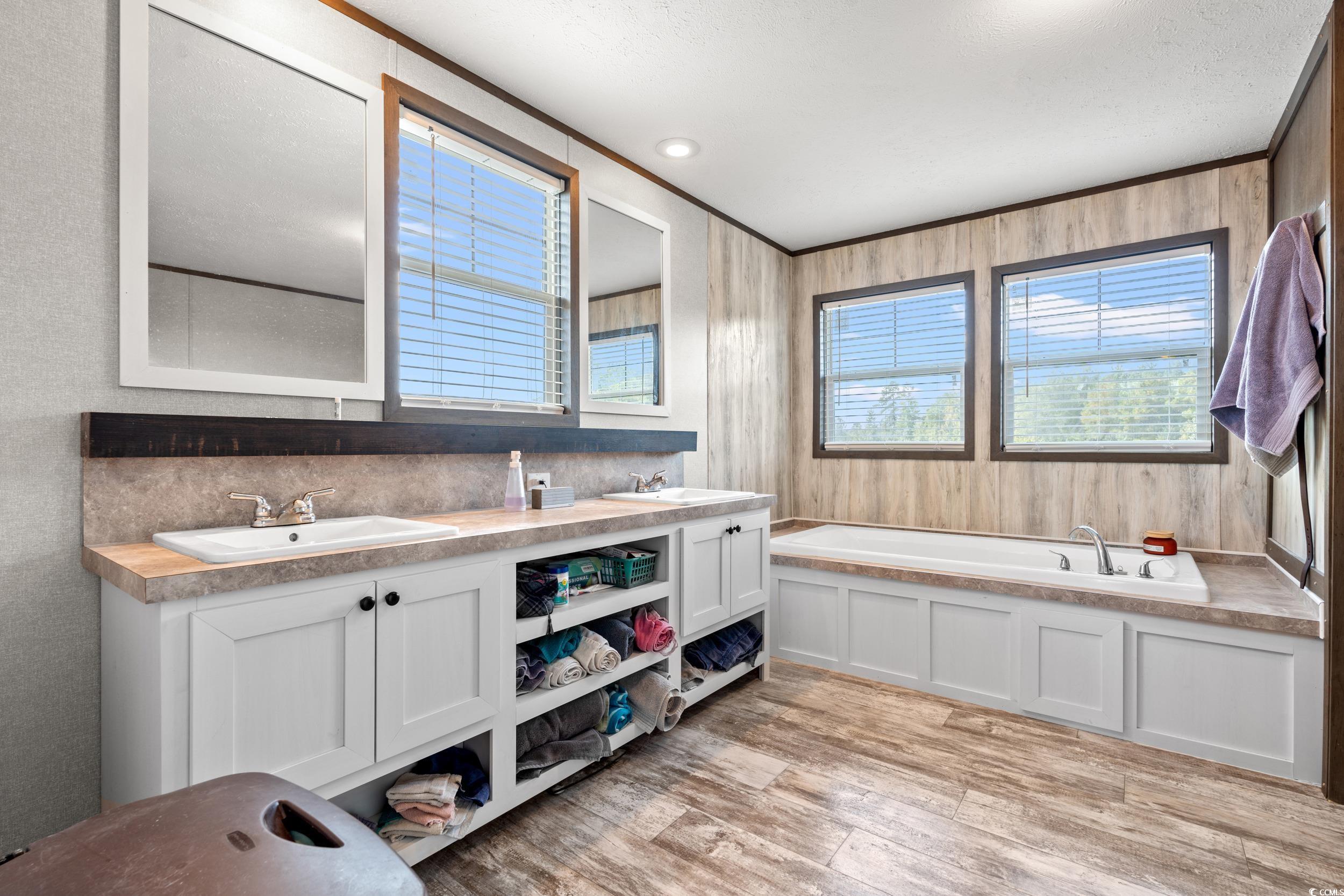 1217 Poplar Creek Road Lake View, SC 29563 - Photo 15 of 38 Full bathroom with a bath, double vanity, light wood-type flooring, and crown molding
