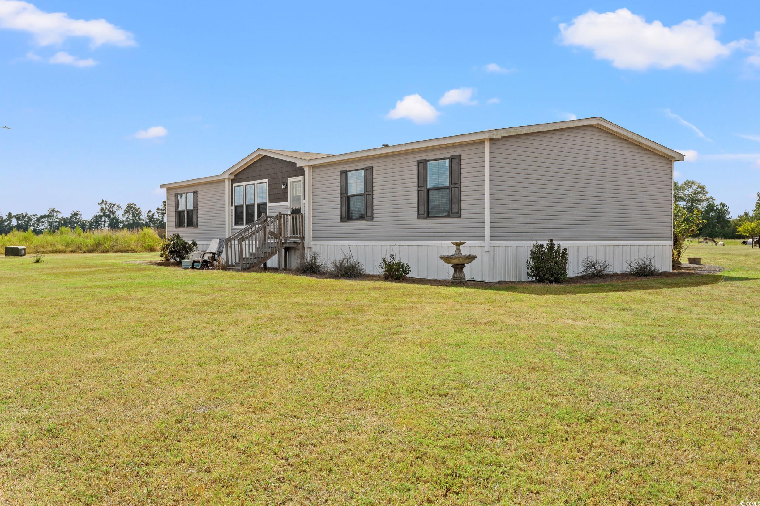 1217 Poplar Creek Road Lake View, SC 29563 - Photo 24 of 38 Manufactured / mobile home with a front yard