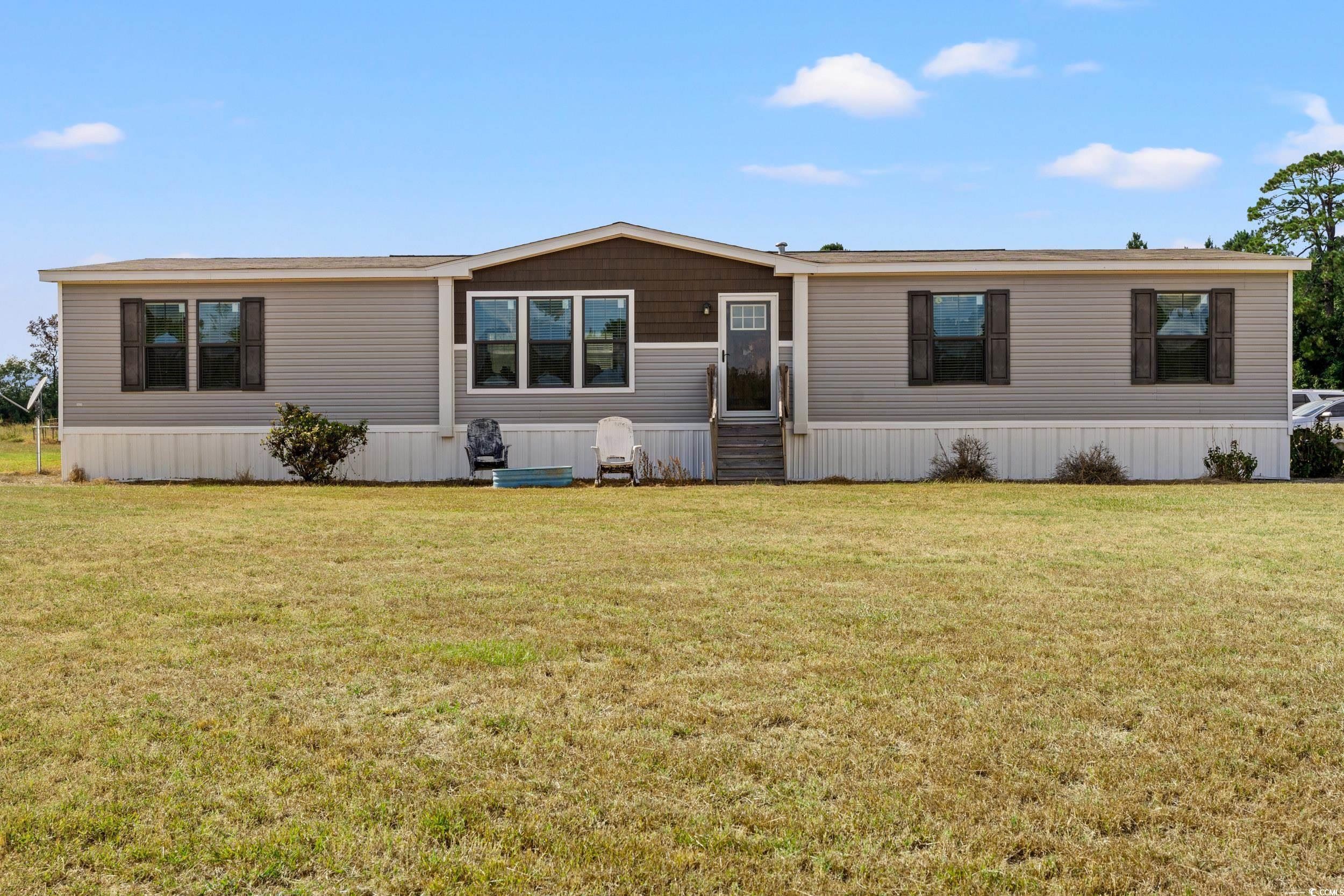 1217 Poplar Creek Road Lake View, SC 29563 - Photo 25 of 38 Manufactured / mobile home featuring a front lawn and entry steps