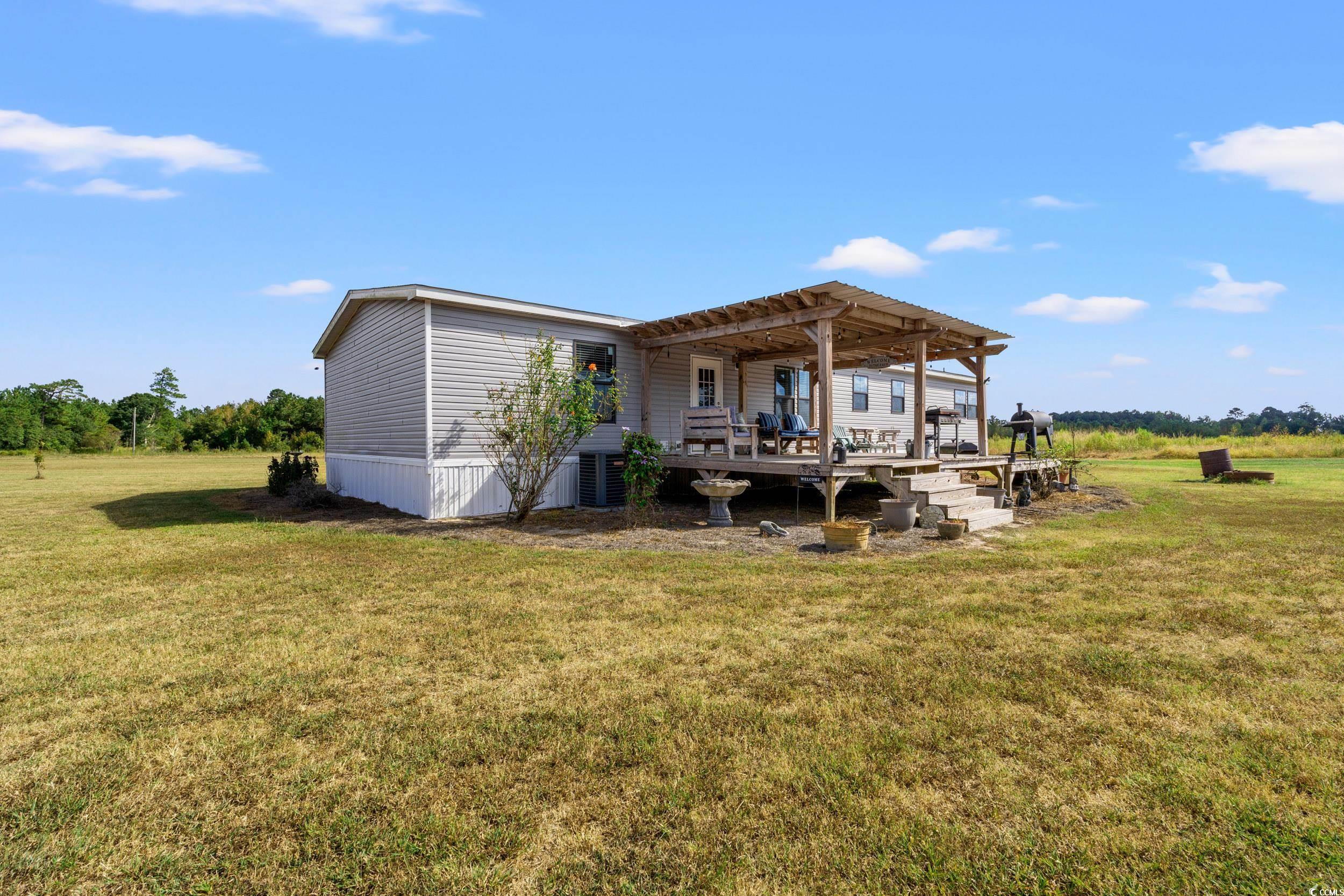 1217 Poplar Creek Road Lake View, SC 29563 - Photo 26 of 38 Back of property featuring a lawn and a wooden deck