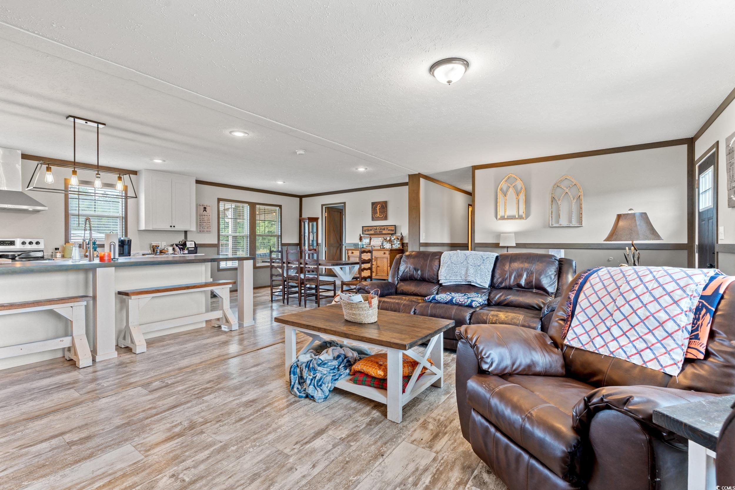 1217 Poplar Creek Road Lake View, SC 29563 - Photo 4 of 38 Living room featuring crown molding, light wood-style floors, and recessed lighting