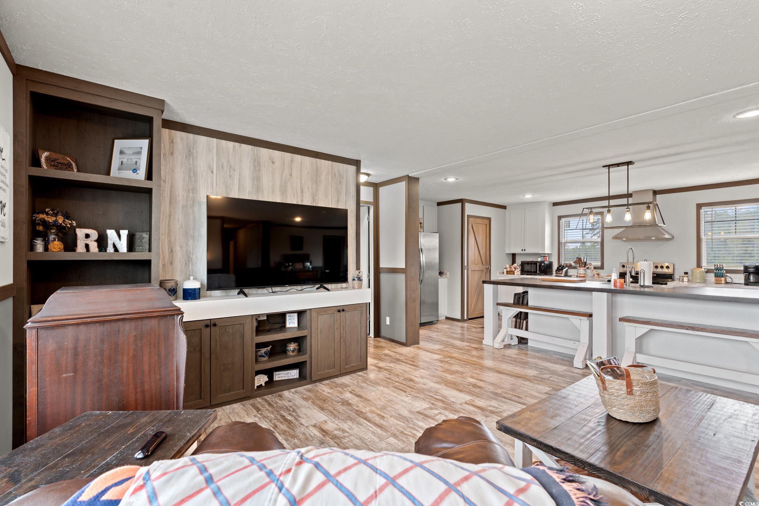 1217 Poplar Creek Road Lake View, SC 29563 - Photo 5 of 38 Living room with light wood-type flooring, a textured ceiling, and ornamental molding