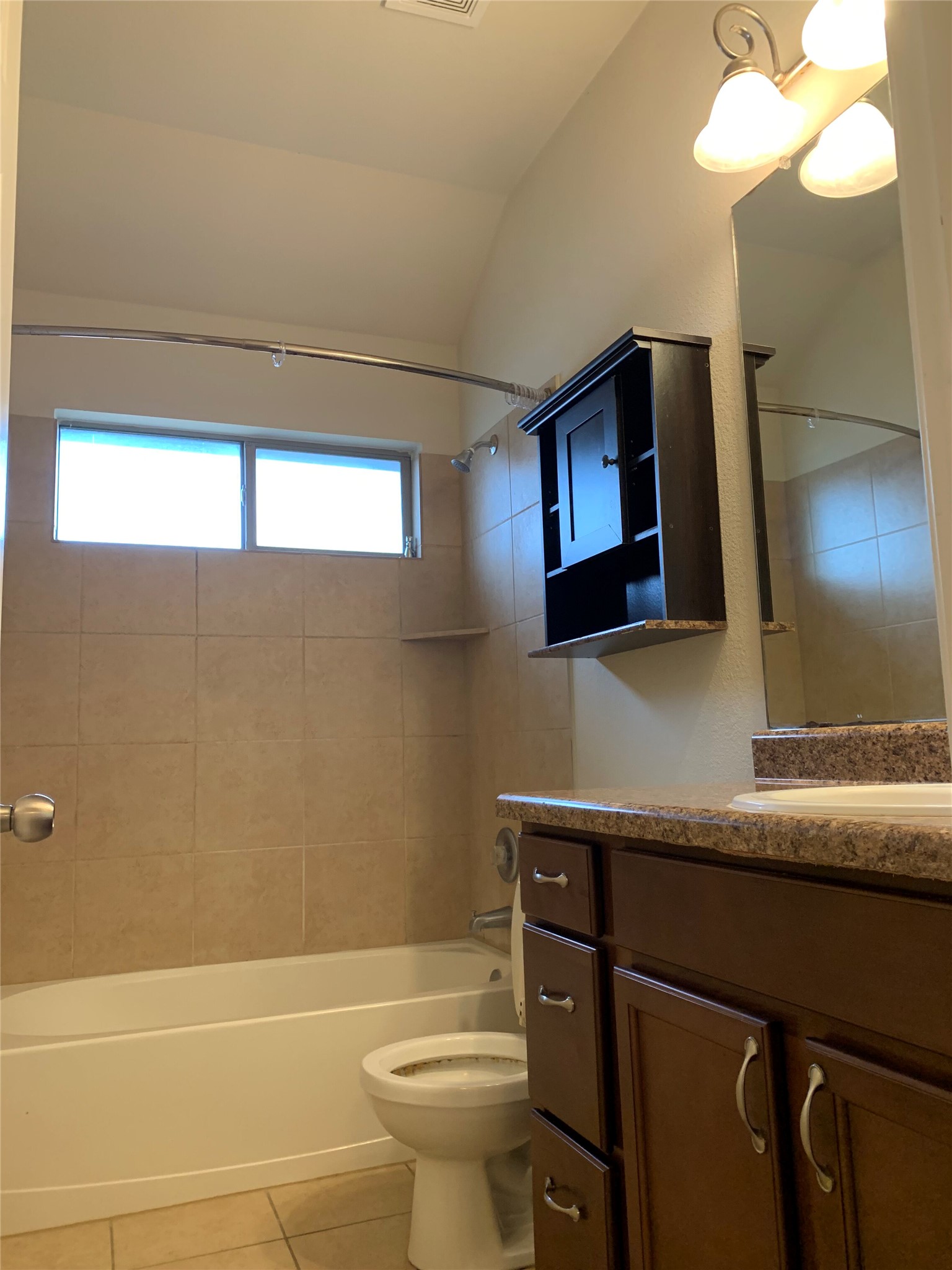 117 Antelope Plains Road Buda, TX 78610 - Photo 6 of 24 High ceilings and neutral wall tile bring depth to this functional bathroom space.