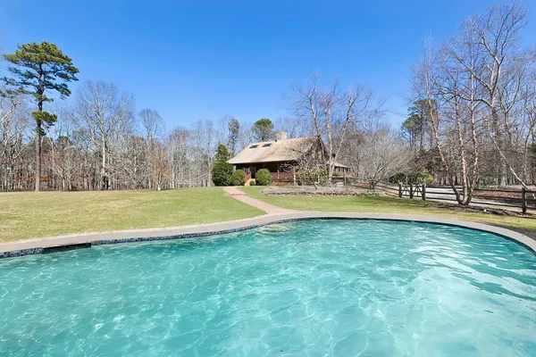 a view of swimming pool with an outdoor space and seating area