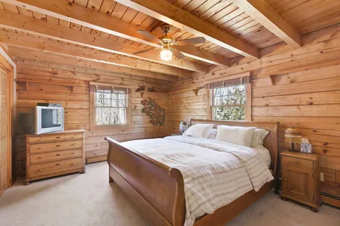 a bed sitting in a bedroom next to a window