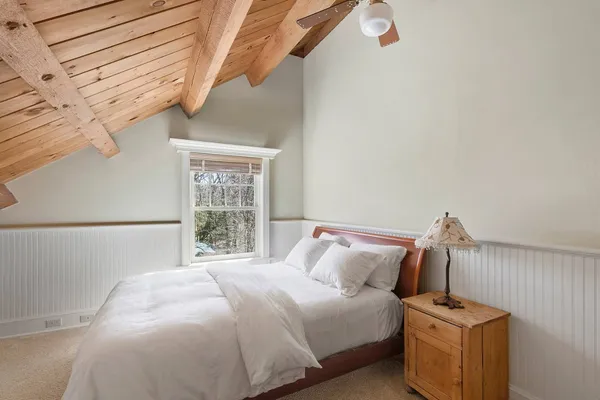 a bedroom with a bed and a window