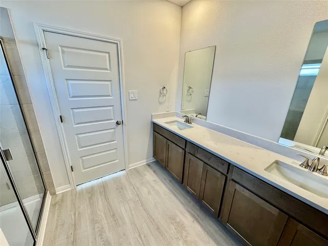 a bathroom with a double vanity sink and mirror