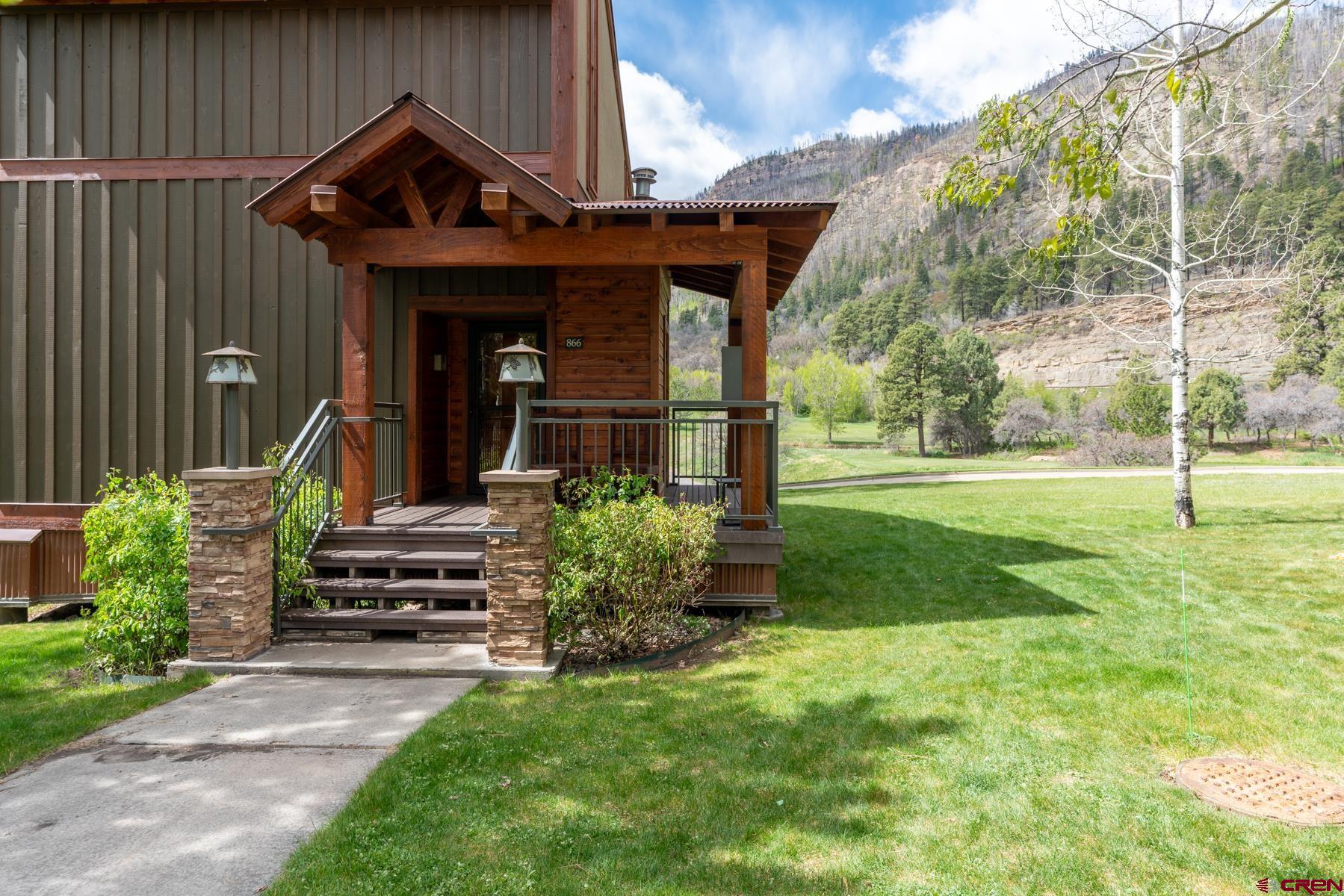 73 Tamarron Drive, Unit 866 Durango, CO 81301 - Photo 32 of 34 a view of a house with backyard and porch