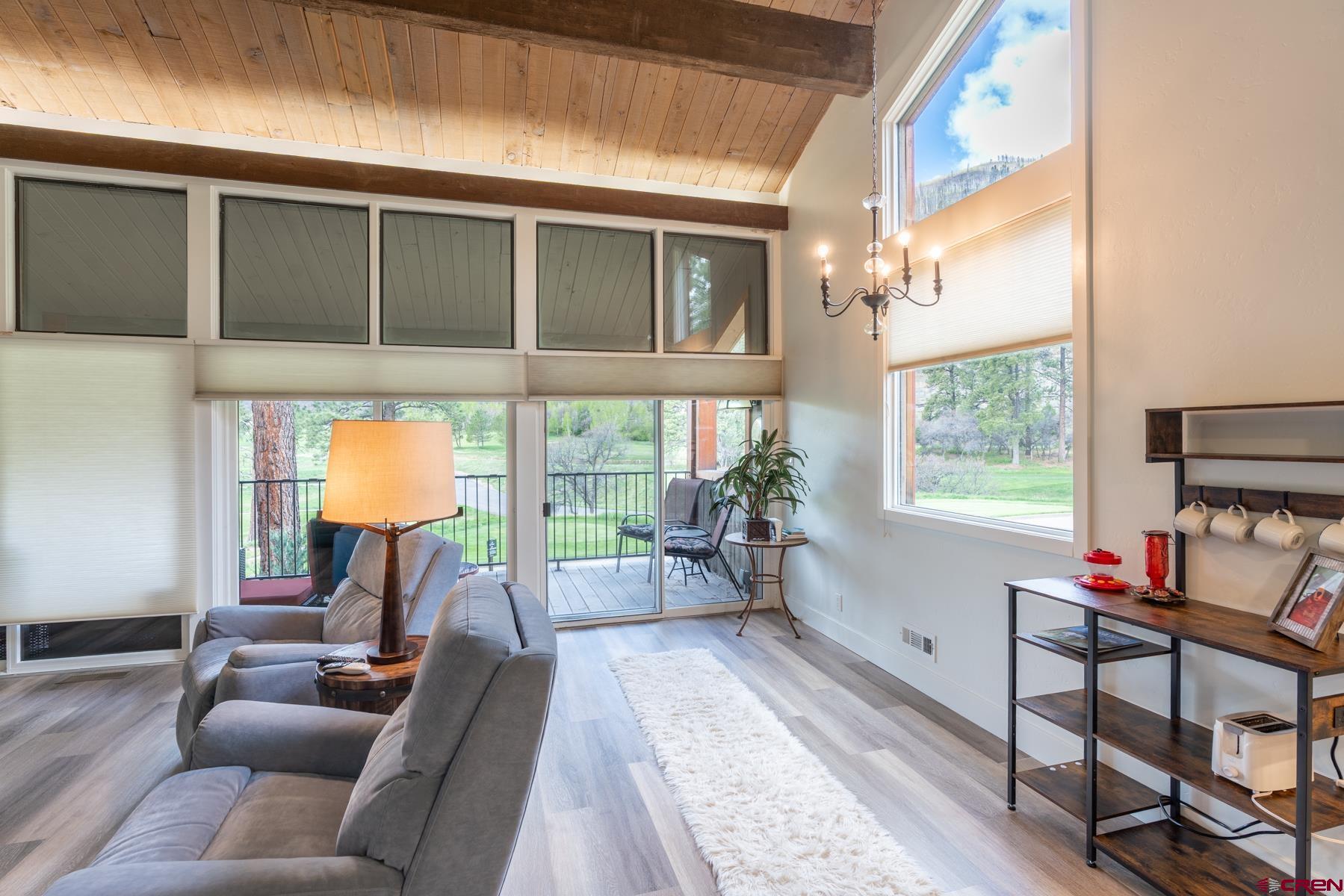 73 Tamarron Drive, Unit 866 Durango, CO 81301 - Photo 7 of 34 a living room with furniture and a floor to ceiling window