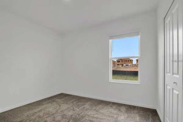 a view of kitchen and empty room