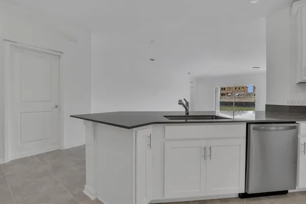 a kitchen with stainless steel appliances a refrigerator sink and stove