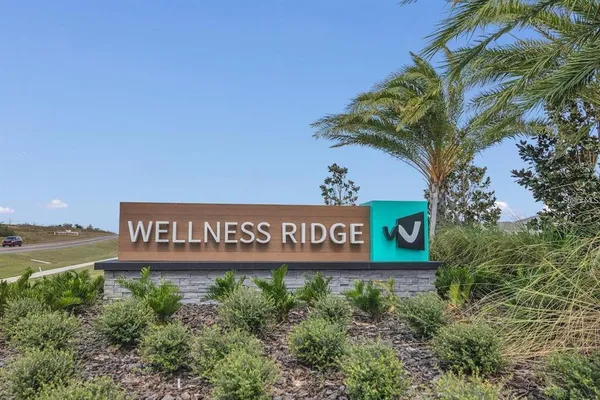 a sign broad in front of a road