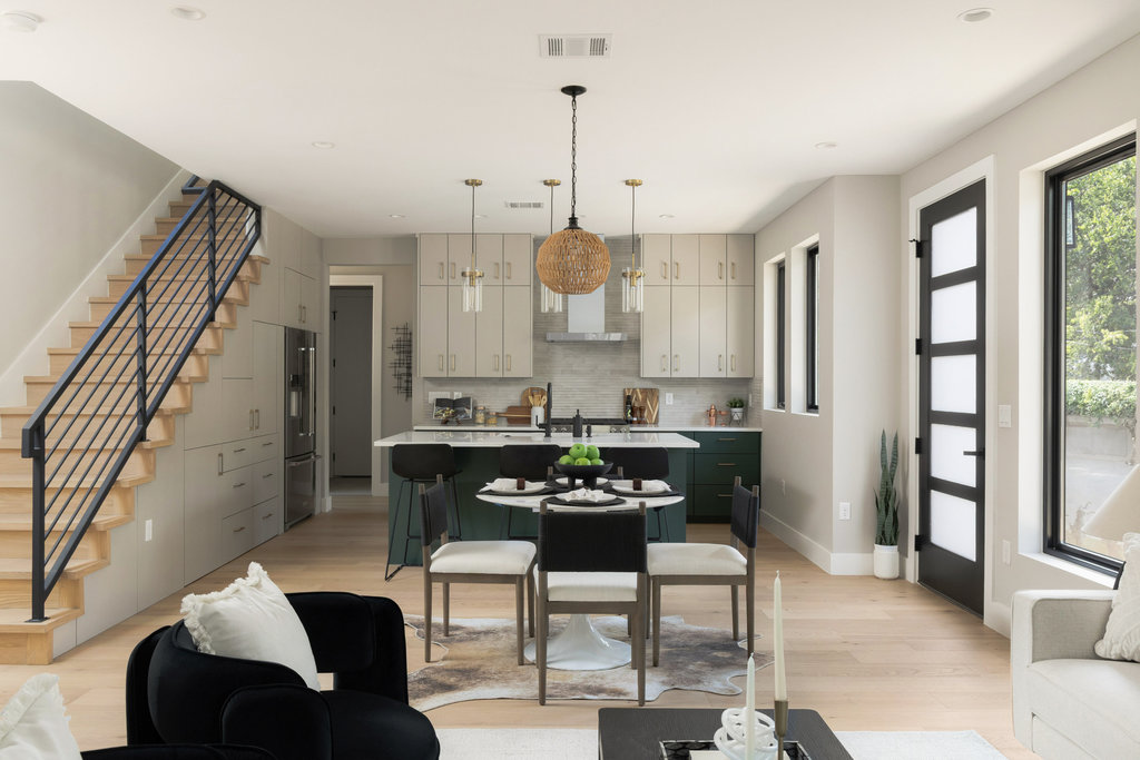 1401 East 3rd Street, Unit 1 Austin, TX 78702 - Photo 12 of 40 Kitchen featuring a center island with sink, hanging light fixtures, a breakfast bar area, light wood finished floors, and backsplash