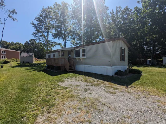 a backyard of a house with plants and tree
