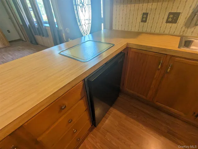 a kitchen with a sink and wooden cabinets