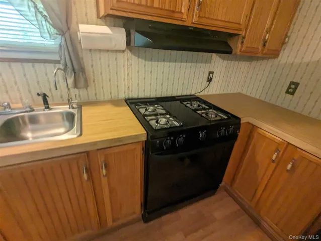 a kitchen with a stove and a sink