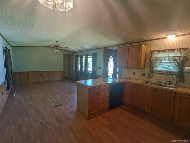a kitchen with cabinets and wooden floor