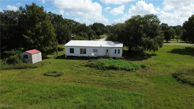 a view of a house with a yard and sitting area
