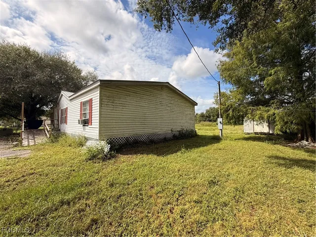 a view of backyard of house with green space