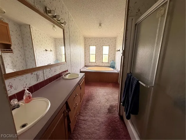 a bathroom with a double vanity sink and mirror